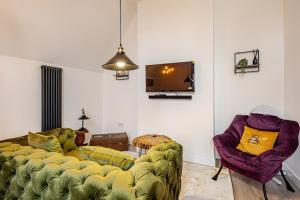 a living room with a couch and two chairs at Perfect Base for Work or Leisure Unique Two-Bed in Irlam