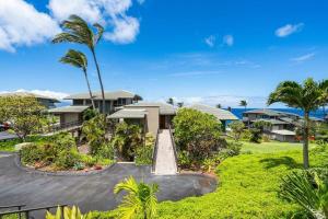 a view of a house with a palm tree at Kapalua Bay Villas 32B4 · KBV 32B4 Oceanfront Kapalua Spectacula in Kahana
