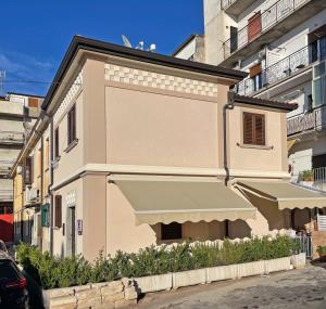 a building with awnings on the side of it at Residenza Degli Dei in Tropea +18 photos