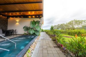 a swimming pool in the backyard of a house at Villas Jawara ! Un Volcán en su Jardín ! in Fortuna