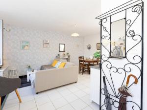 a living room with a couch and a dining room at Holiday Home Le Nid de Cancale by Interhome in Cancale