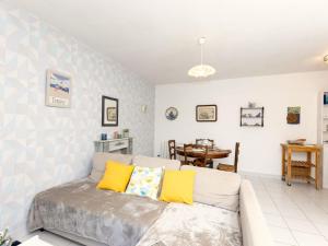 a living room with a couch and a table at Holiday Home Le Nid de Cancale by Interhome in Cancale