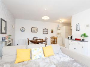 a living room with a couch and a kitchen at Holiday Home Le Nid de Cancale by Interhome in Cancale +18 photos