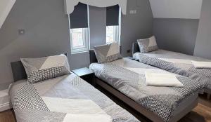 a room with two beds in a room at Twelfth Man Accommodation part of The Twelfth Man Public House in Liverpool