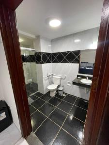a bathroom with a toilet and a sink at Manancial Hotel in Paracatu +18 photos