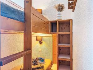a bedroom with a bunk bed with a ladder at Studio Les Olympiades-23 by Interhome in Val Thorens +19 photos