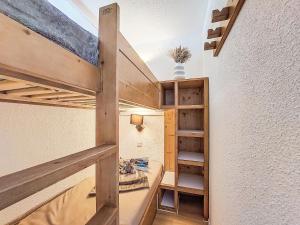 a small room with a bunk bed and shelves at Studio Les Olympiades-23 by Interhome in Val Thorens