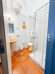 a bathroom with a shower and a toilet and a sink at Costa Cabral Porto Flat in Porto