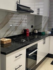 a kitchen with a stove top oven in a kitchen at Cozy apartment in Kenitra