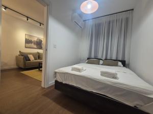 a bedroom with a large bed and a couch at Lastavica residence, modern luxury apartment with free garage in Novi Beograd