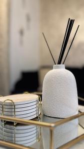 a stack of plates and chopsticks on a table at Irenic Luxury Rentals in Coventry