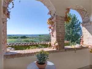 a room with a window and a table with a plant at Apartment La Foresta-3 by Interhome in Quercegrossa