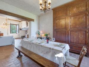 a large dining room with a table with a white table cloth at Apartment La Foresta-3 by Interhome in Quercegrossa
