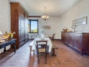 a dining room with a table with a white table cloth at Apartment La Foresta-3 by Interhome in Quercegrossa +56 photos
