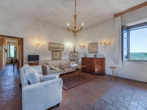a living room with a couch and a table at Apartment La Foresta-3 by Interhome in Quercegrossa