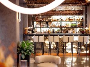 a bar with stools in front of a bar at Pullman Riga Old Town - Renovated 2025 in Rīga