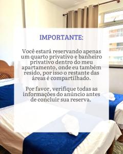 a sign in a room with a bed at Quarto Privativo na AvBeira mar - Apto familiar in Fortaleza