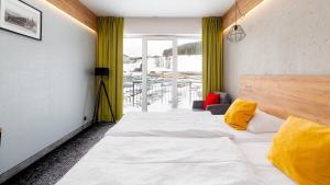 a row of beds in a room with a window at Czarna Perła Apartamenty z bezpłatnym basenem Czarna Góra Resort in Sienna +32 photos