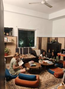 a group of people sitting in a living room at Hotel NoVo Agra in Agra