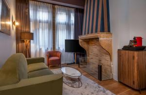 a living room with a couch and a fireplace at Cour des Loges Lyon, A Radisson Collection Hotel in Lyon