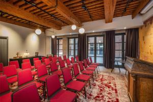 a room with red chairs and a piano at Cour des Loges Lyon, A Radisson Collection Hotel in Lyon +120 photos