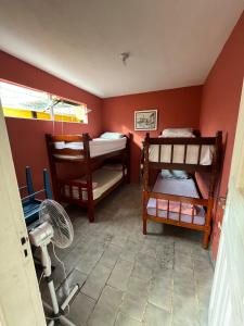 a room with two bunk beds and a fan at Hostel da Luna in Paraty