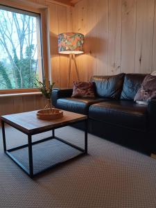 a living room with a couch and a coffee table at Gîte Jurassien in Clairvaux-les-Lacs