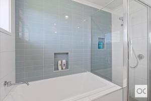a bathroom with a shower with a glass door at Amazing Views in Middleton +42 photos