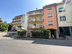 an apartment building with a dog in front of it at Il Centro Apartments 2 in Salsomaggiore Terme