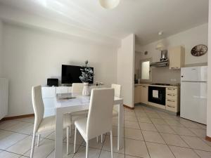 a kitchen and dining room with a table and chairs at Il Centro Apartments 2 in Salsomaggiore Terme