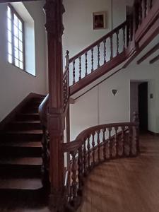 a wooden staircase in a building with a window at Château de Villechauvon in Vatan