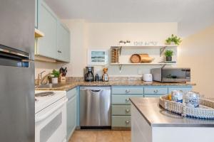 a kitchen with blue cabinets and a counter top at Napili Shores D126 · NSD126 Cozy Studio Steps to Beach in Kahana