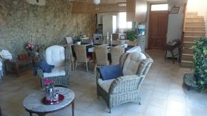 a living room with wicker chairs and a table at The Villa Sunlight in Sitges