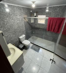 a bathroom with a shower and a toilet and a sink at Residencial Esperança in Nova Iguaçu