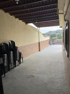 a row of black chairs sitting on a patio at Residencial Esperança in Nova Iguaçu