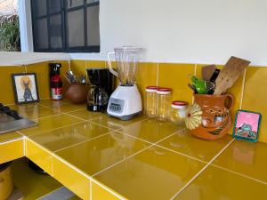 a yellow counter top with a blender on it at Casa Kata in Zipolite