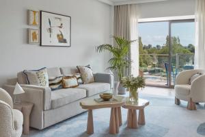 a living room with a couch and a table at Hotel Camiral - The Leading Hotels of the World in Caldes de Malavella