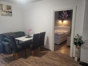 a room with a table and chairs and a bedroom at Apartman D&D 1 in Jajce
