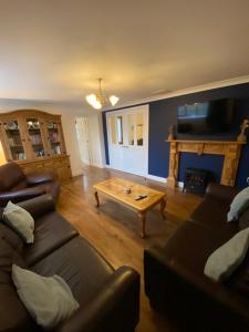 a living room with a couch and a coffee table at The Dairy in Bagilt