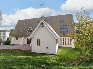 a white house with a gambrel roof at Lady Of Lourdes in Whitchurch