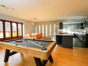 a living room with a pool table and a kitchen at Lady Of Lourdes in Whitchurch