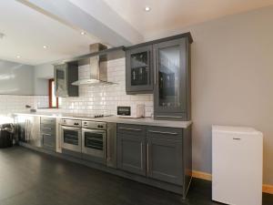 a kitchen with gray cabinets and a counter top at Lady Of Lourdes in Whitchurch