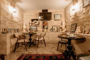 a room with two tables and some statues on the wall at Sazeli Boutique Hotel in Baku +112 photos