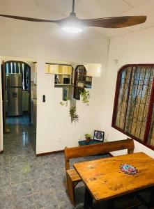 a room with a wooden table and a bench at Maudie in Santa Teresa Beach