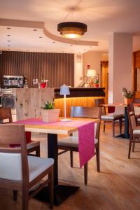 a dining room with a table and chairs at Olympic regina hotel in Pinzolo