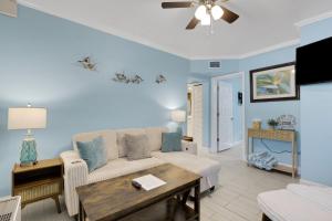 a living room with a couch and a table at Clearwater Beach Suites #102 in Clearwater Beach