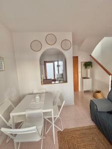 a living room with a white table and chairs at Villa Banfield in Gran Alacant