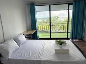a bedroom with a white bed and a large window at Top View Kohrong in Koh Rong +63 photos