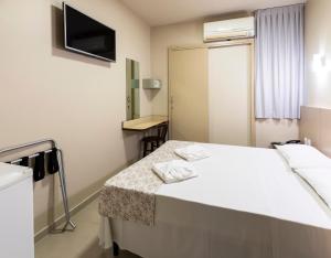 Postel nebo postele na pokoji v ubytování Hotel Pitol