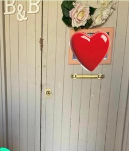 a heart on a wall with a picture and flowers at Love Gioia Tauro in Gioia Tauro +4 photos